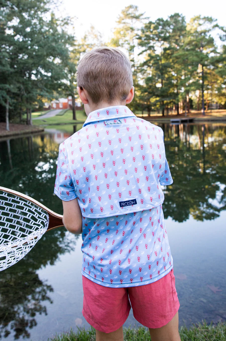 BOYS SHORT SLEEVE PRO PERFORMANCE POLO IN CRAB AND LOBSTER PRINT ON LIGHT BLUE