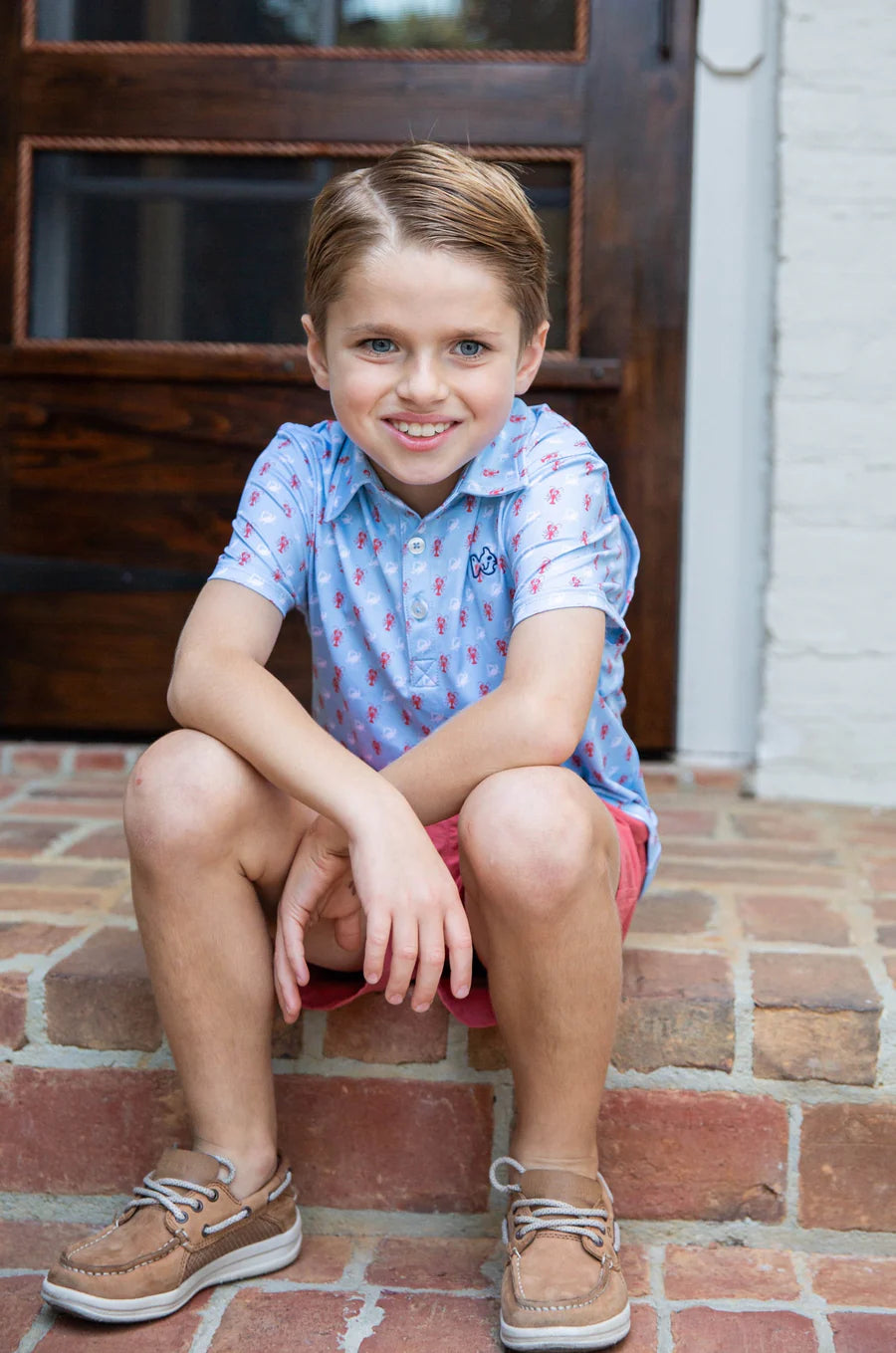 BOYS SHORT SLEEVE PRO PERFORMANCE POLO IN CRAB AND LOBSTER PRINT ON LIGHT BLUE