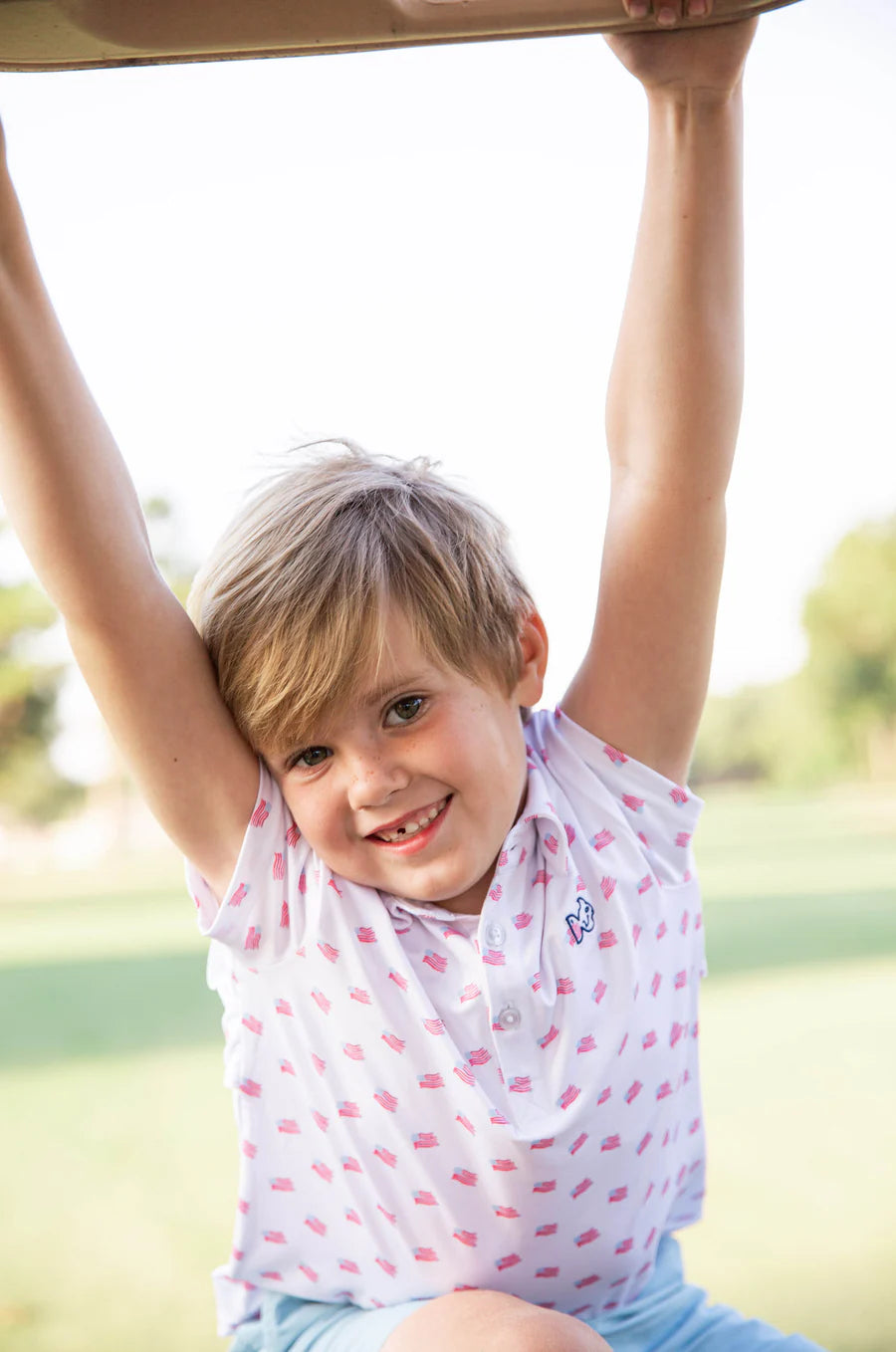 BOYS SHORT SLEEVE PRO PERFORMANCE POLO IN AMERICAN FLAG PRINT