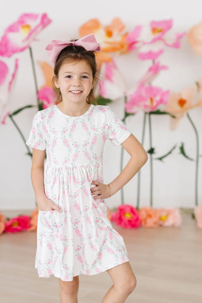 mila & rose short sleeve soft twirly dress with pockets in rosie posie print.  white background with pink roses