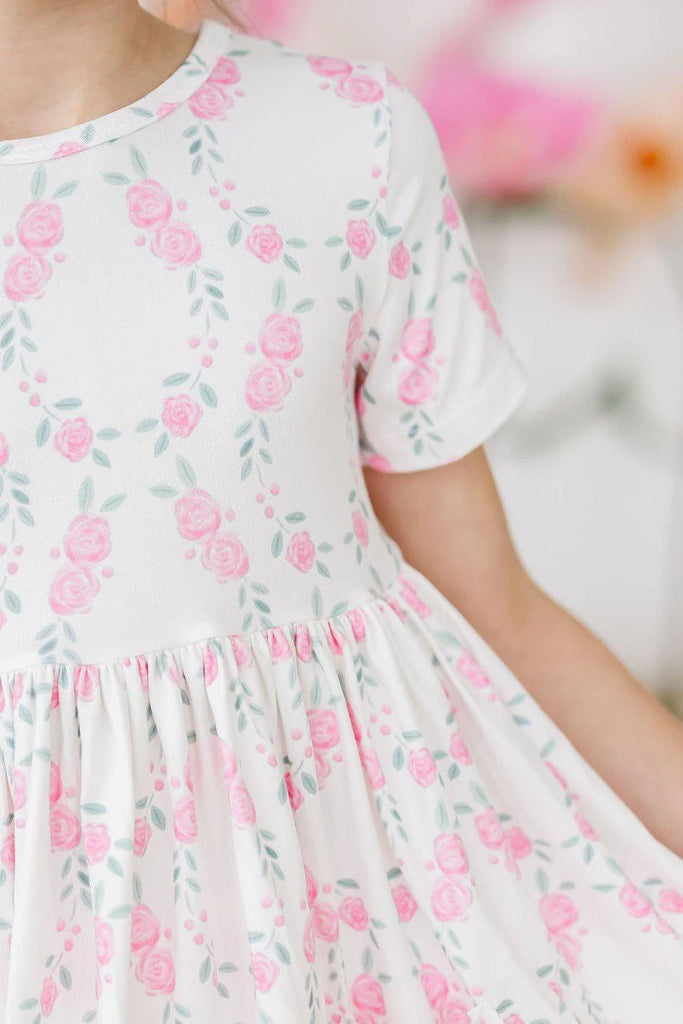 mila & rose short sleeve soft twirly dress with pockets in rosie posie print.  white background with pink roses